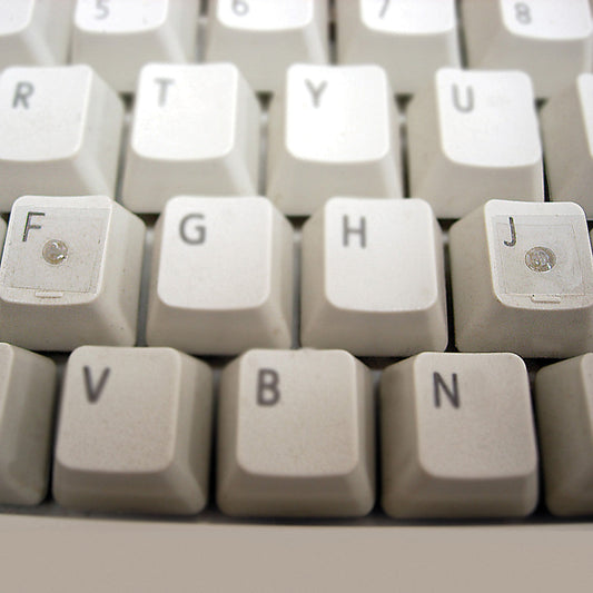 Two Spotter Loc-Dots on the F and the J key of a keyboard