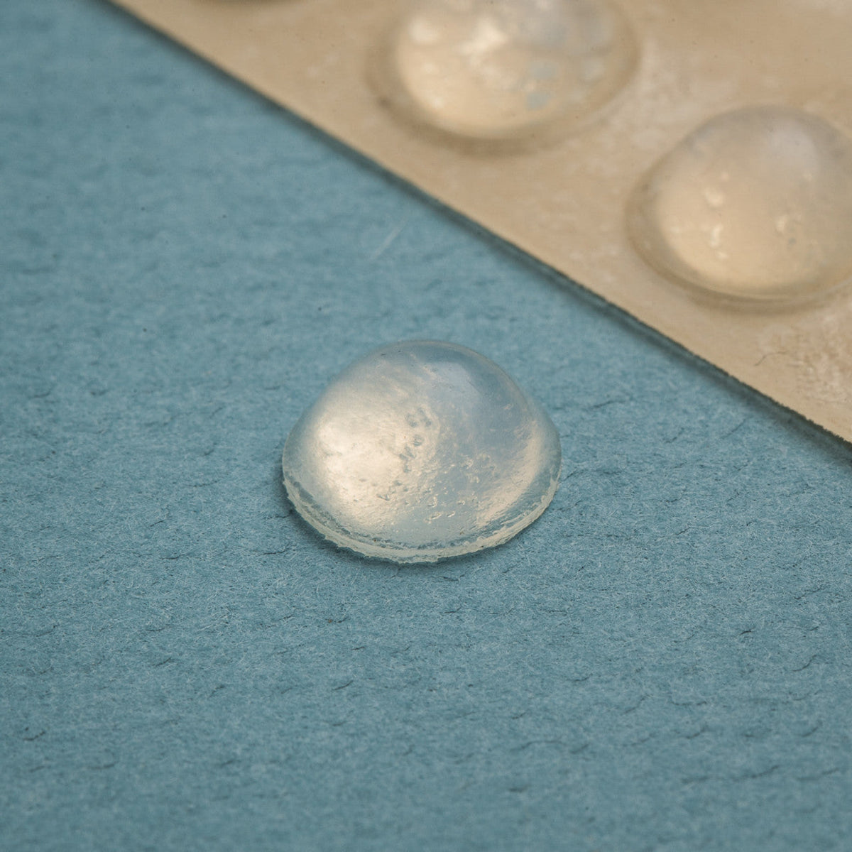  25 clear medium Can Do Bump dots. One silicone rubber bump with adhesive back that adheres to just about any smooth surface. Bumps measure 9.5 mm (.37") in diameter by 3.8 mm (.15") in height.