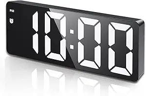 Compact black digital alarm clock with large white LED display showing 10:00, PM indicator, and alarm icon